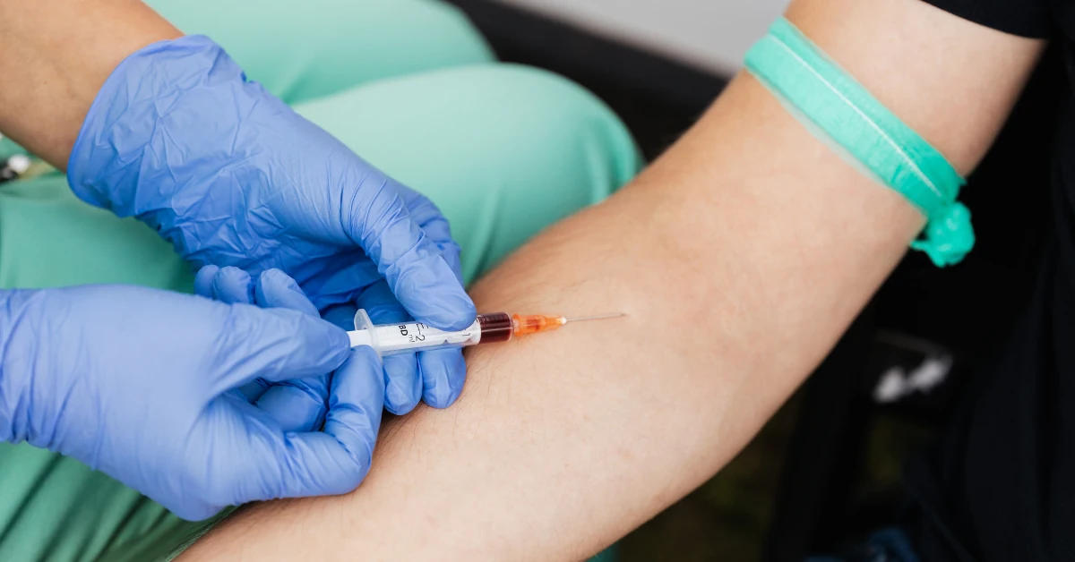 Healthcare professional collecting a blood sample for hormone analysis, supporting personalized women’s health and hormone testing.