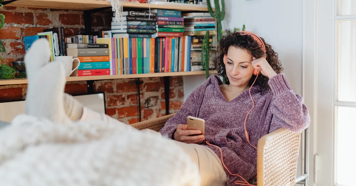 Person resting in a comfortable chair at home, soft daytime light