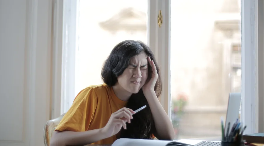 Daily migraine and energy log on a notepad