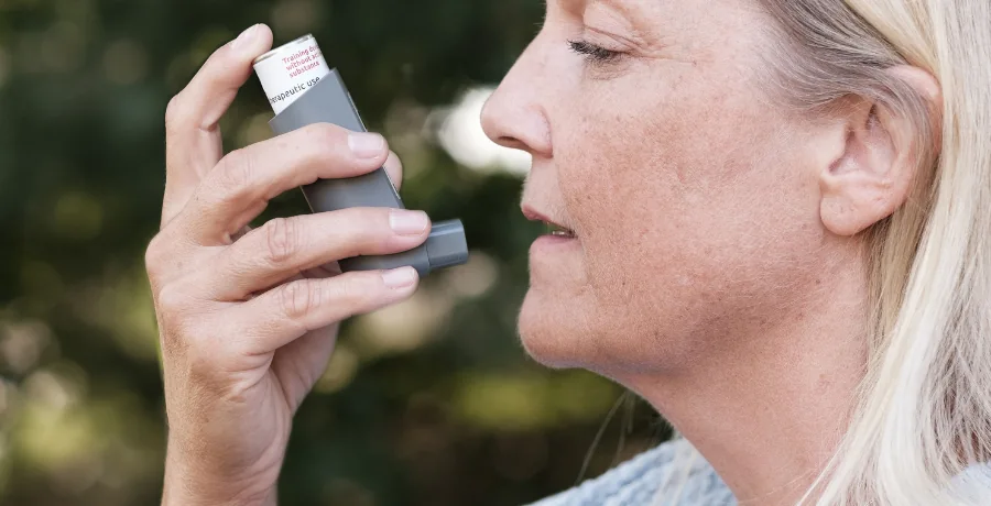 Simple daily breathlessness and energy log next to an inhaler
