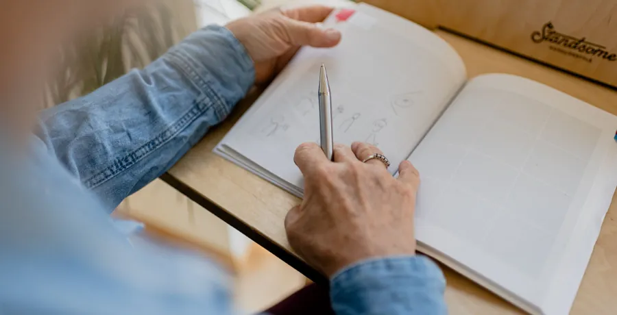 A simple daily symptom log next to a cup of tea, low-key and everyday