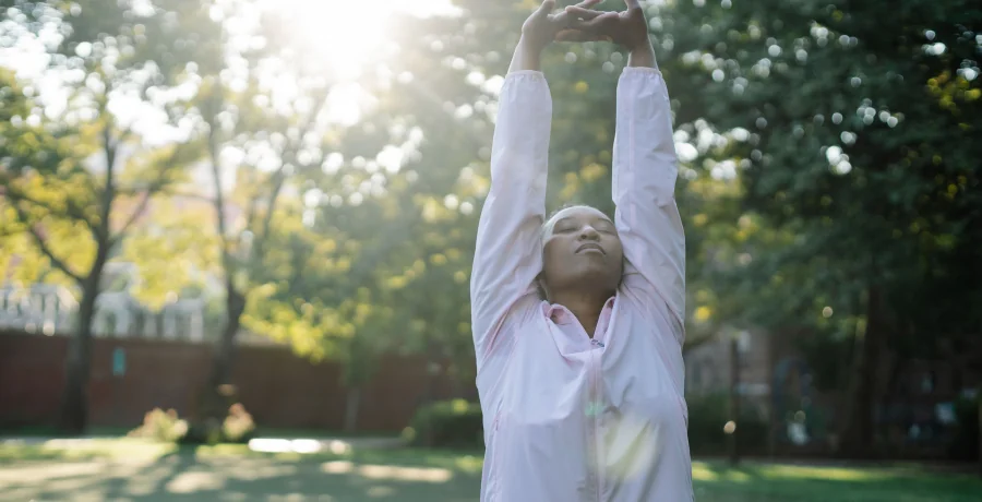 A person doing gentle stretching or a short walk outdoors, calm and realistic