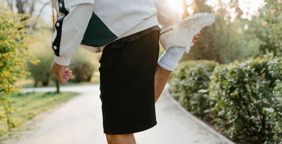 A person doing gentle stretching or a short walk outdoors, calm and realistic