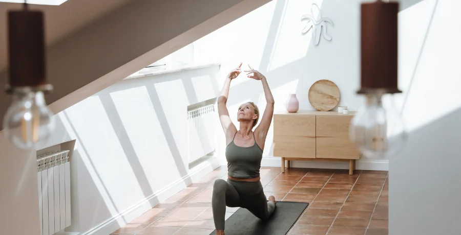 A person doing gentle mobility exercises or yoga at home, calm and realistic