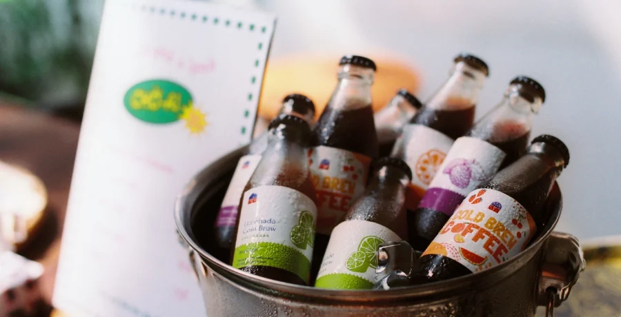Flat-lay of unbranded drinks, each with a small mg label card
